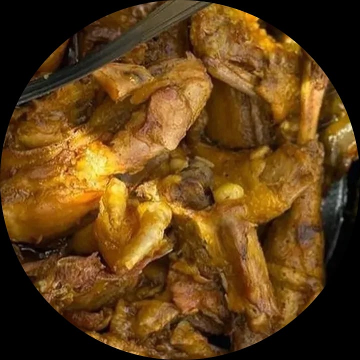 Galinha caipira ensopada no molho, servida na panela de pedra